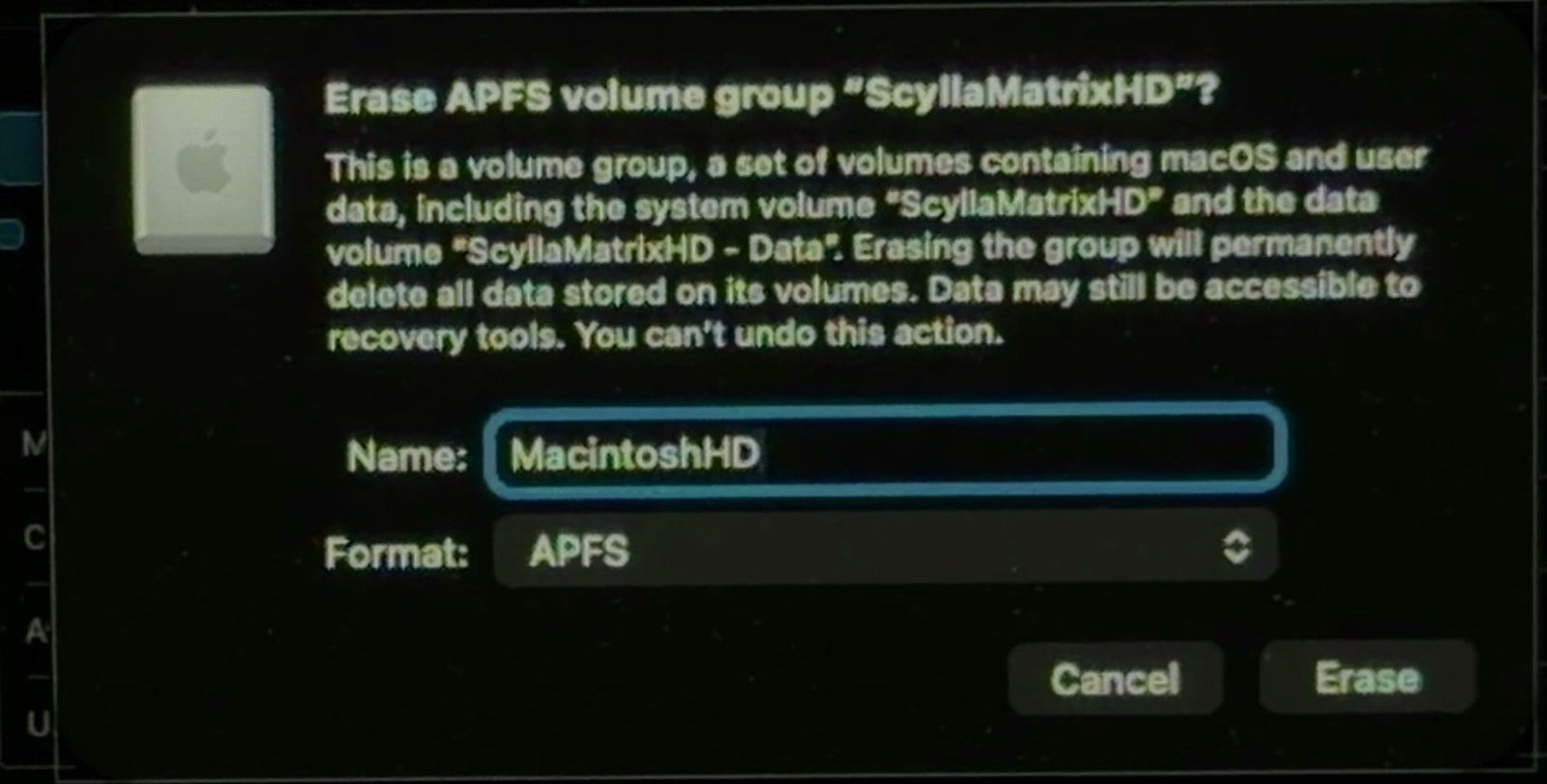 Disk Utility in the macOS Tahoe recovery environment confirming Erase APFS volume group with the name MacintoshHD and the APFS format selected.