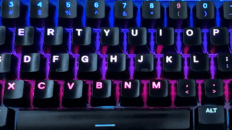 Backlit keyboard close-up representing accurate touch typing technique