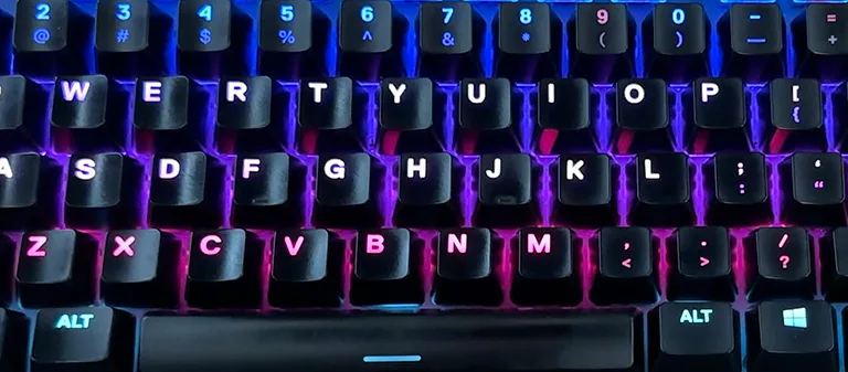 Backlit keyboard close-up representing accurate touch typing technique